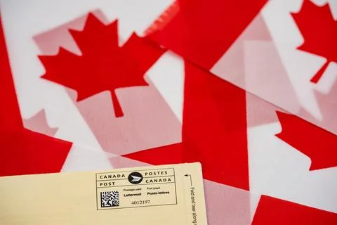 Close up of Canada Post envelope on Canadian flags. Toronto, Canada - July 8, Stock Photos