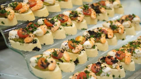 Close-up of canapes on a beautiful stand on a buffet table in a restaurant. Stock Footage 269931783
