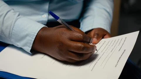 Close up of candidate filling in registration forms for job application Stock Photos