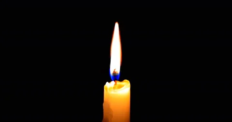 Close-up of candle burn with glow flame fire sparkle on black background Stock Footage 169640125