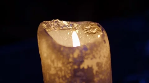 A close-up of a candle burning in the dark, creating a soft and intimate gl.. Stock Footage 285883615