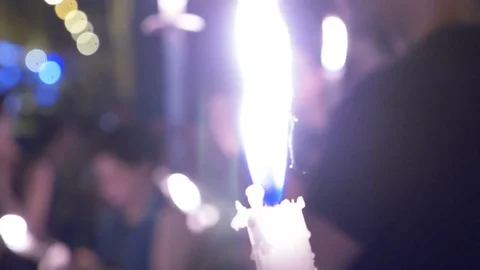 Close up on Candle burning during a torchlight procession: people, symbol,  Stock Footage 78227226