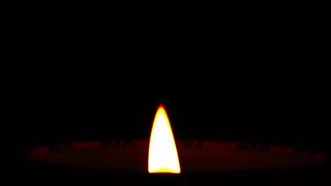 Close-up of candle flame burning on a black background. Stock Footage 248334069