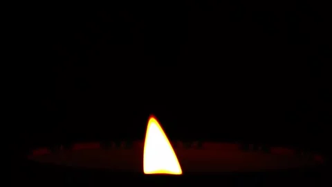 Close-up of candle flame burning on a black background. Stock Footage 248334525