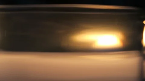 Close up of candle flame through glass optical distortion makes it abstract￼ Stock Footage 119077537