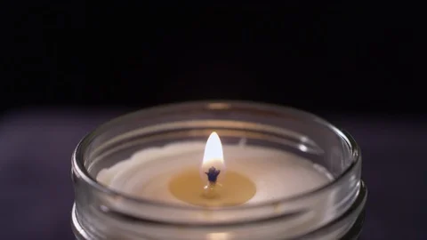 Close-up of a candle getting blown out on a black background Video stock 119095627