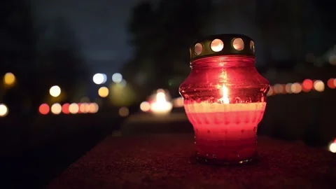 Close-up of candle lantern burning in a cemetery on the tombstone on all saints Stock Footage 151160468