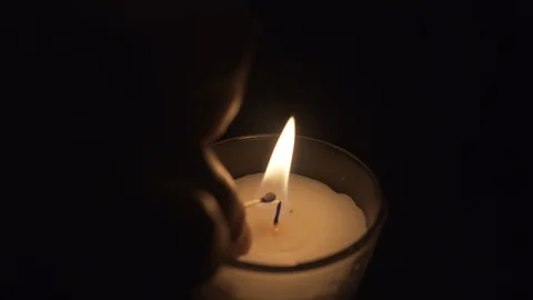 Close up of a candle lighting up in a black background Stock Footage 96453630