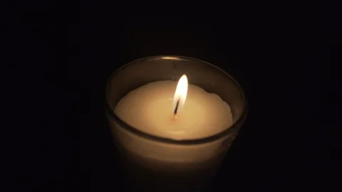 Close up of a candle lighting off in a black background Stock Footage 96462905