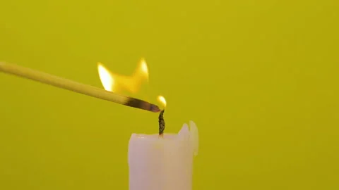 Close-up candle wick lit with splinter on yellow background, it is blown out Stock Footage 145132204