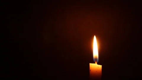 Close-up of a Candlelight Isolated on a Black Background Stock Footage 125362837