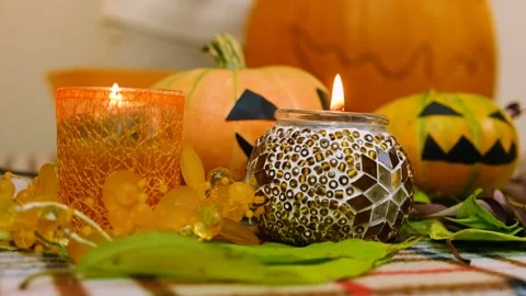 Close-up. Candles burn on the background of a pumpkin. Slow motion. Stock Footage 219257115