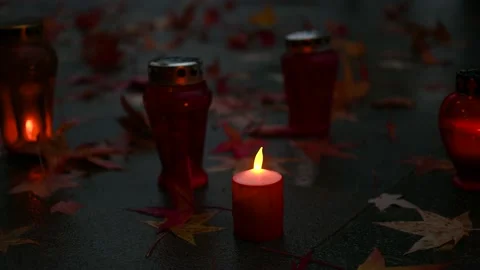 Close up: candles burning at a cemetery during All Saints Day Stock Footage 183016419