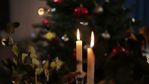 Close-up candles burning in darkness at background of New Year tree indoors Stock Footage 219921366