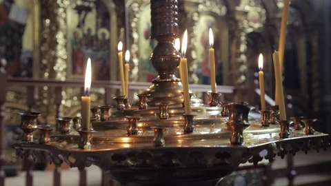 Close-up on candles burning in the temple and wedding rings Stock Footage 88859249