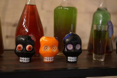 Close-up of candles in the form of multi-colored skulls against the background 스톡 사진