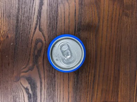 Close up cans of cold energy drinks on a wooden table Stock Photos