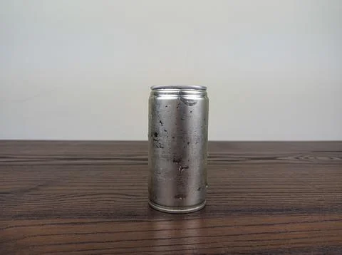 Close up cans of cold energy drinks on a wooden table Stock Photos