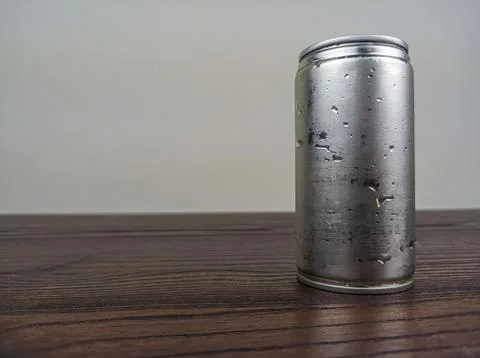 Close up cans of cold energy drinks on a wooden table Stock Photos