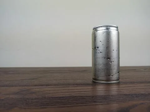 Close up cans of cold energy drinks on a wooden table Stock Photos
