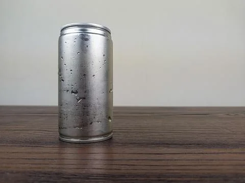 Close up cans of cold energy drinks on a wooden table Stock Photos