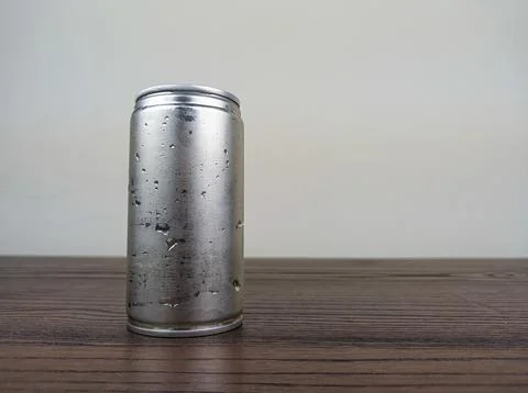 Close up cans of cold energy drinks on a wooden table Stock Photos