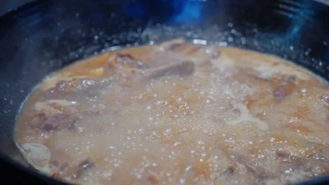 Close-up of Cantonese dish drunk goose boiling in red soup in iron pot Stock Footage 346672078