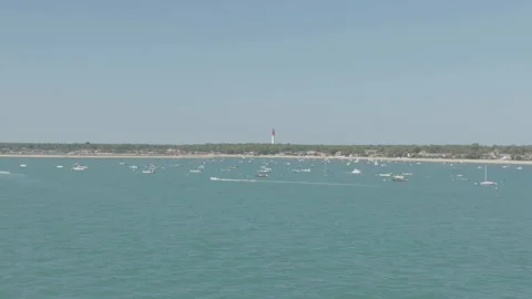 Close-up of Cap Ferret port with lighthouse centered in background, France Stock Footage 333108682