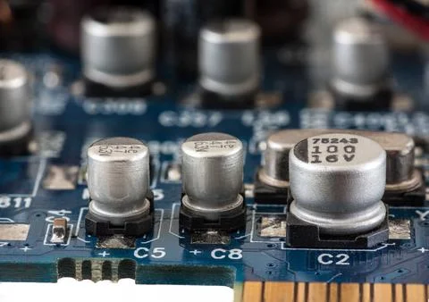 Close up of capacitor on printed computer circuit board Stock Photos