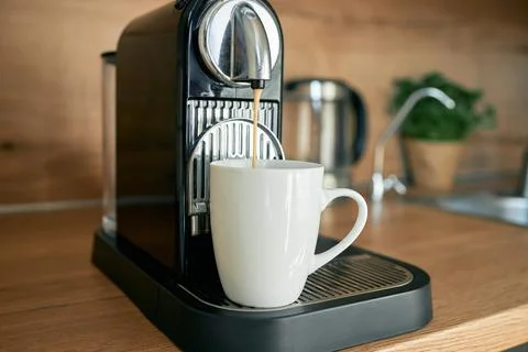 Close-up of a capsule coffee machine making espresso while making coffee Stock Photos