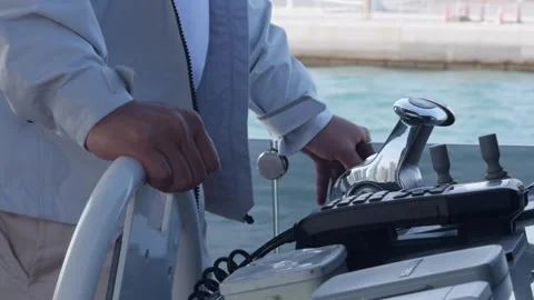 Close-up of the captain's hands at the helm. He controls the movement of the Stock Footage 309361988