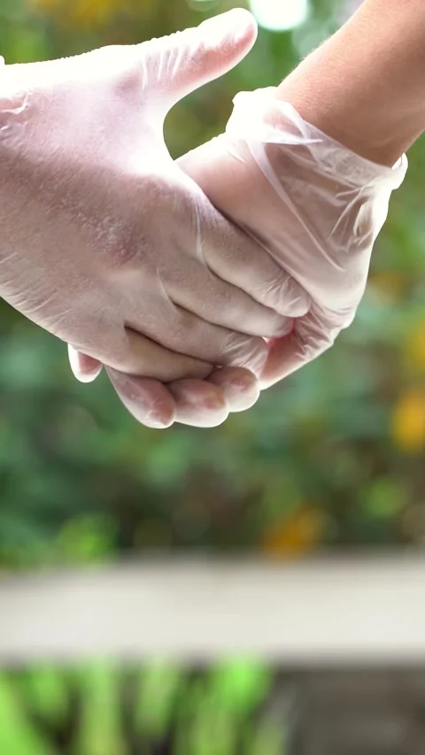 Close up caption of two hands with sanitary gloves holding each other Stock Footage 290464233