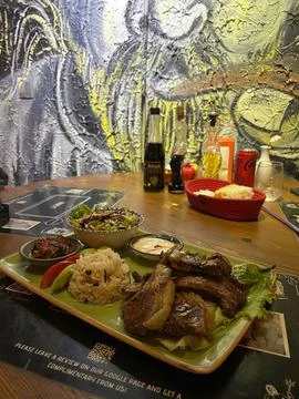 This close-up captures a full meal consisting of grilled lamb chops Stock Photos
