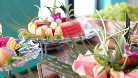 A close-up captures a hand reaching to take a rustic wooden plate filled with Stock-Footage 316315753