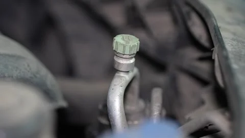 Close-up of a car air conditioning high pressure service port. Vidéo 345911304