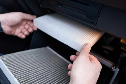 Close-up of a car air filter in the hands of a man Stock Photos