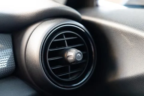 Close up of car air vent with dust particles in sunlight on dashboard interior Fotos Stock