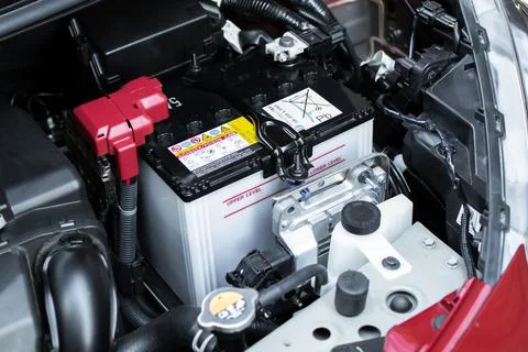 Close up of car battery in engine compartment Stock Photos