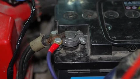 Close-up of a car battery positive terminal with connected wires. Stock Footage 345910252