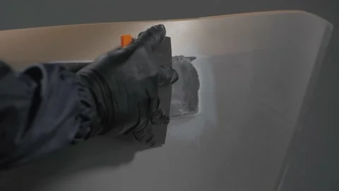 Close-up of car body repair, putty application.  Video stock 202166399