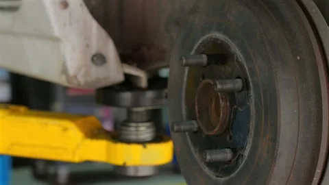 Close-up of car brake assembly being repaired in auto repair shop, Video stock 284653639