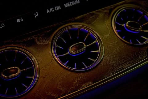 Close-up of car climate control panel with illuminated c Stock Photos