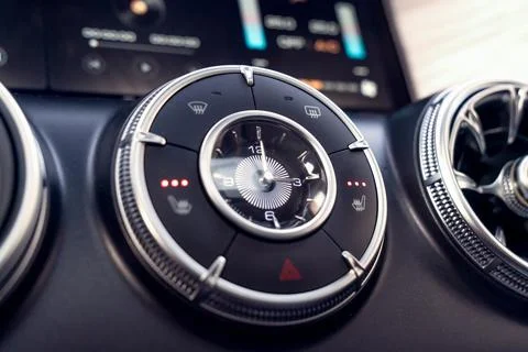 Close up of a car clock, control unit and buttons for seat heating and vent.. Stock Photos