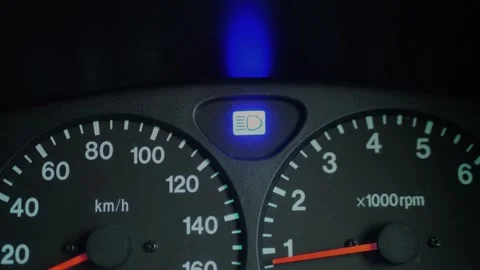Close-up of car dashboard with blue high beam indicator glowing... 動画素材 339101640