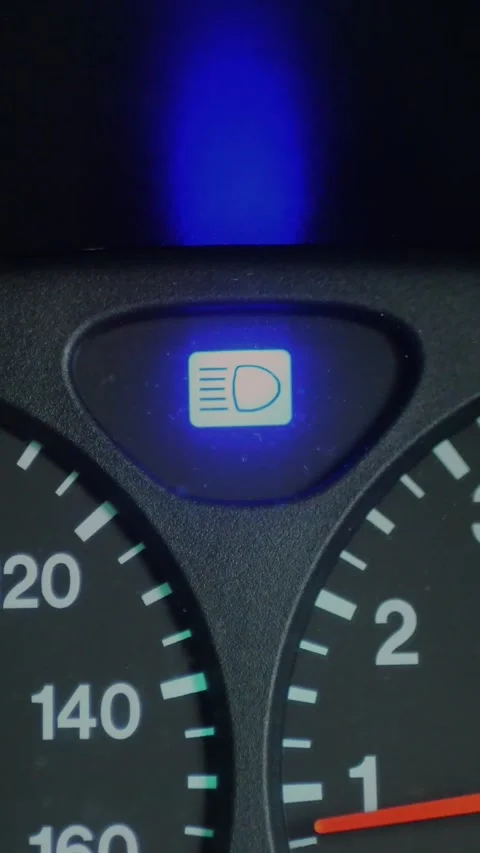 Close-up of car dashboard with blue high beam indicator glowing... Stock Footage 344455318