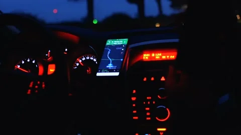 Close-up of car dashboard, control panel with speed gauge, fuel consumption, han Stock Footage 104946867