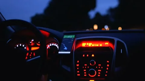 Close-up of car dashboard, control panel with speed gauge, fuel consumption, han Stock Footage 104946900