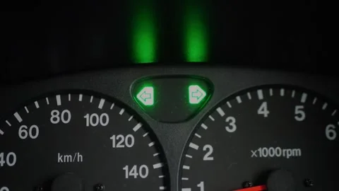 Close-up of car dashboard displaying illuminated green turn signal... 스톡 동영상 339101641