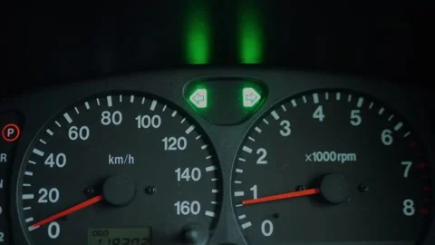Close-up of car dashboard with illuminated green turn signal... 스톡 동영상 339101615
