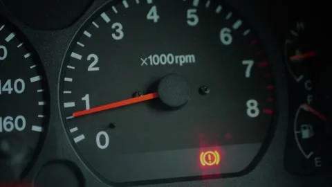 Close-up of car dashboard showing an illuminated red brake... 스톡 동영상 339101604